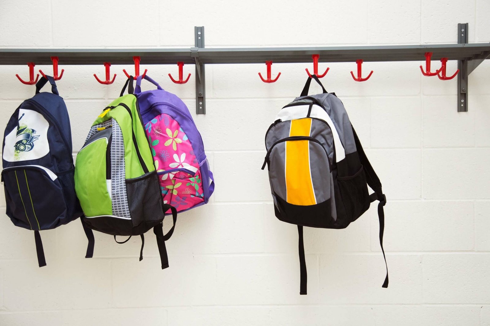 Backpacks multiple backpacks stored on a hanging rack