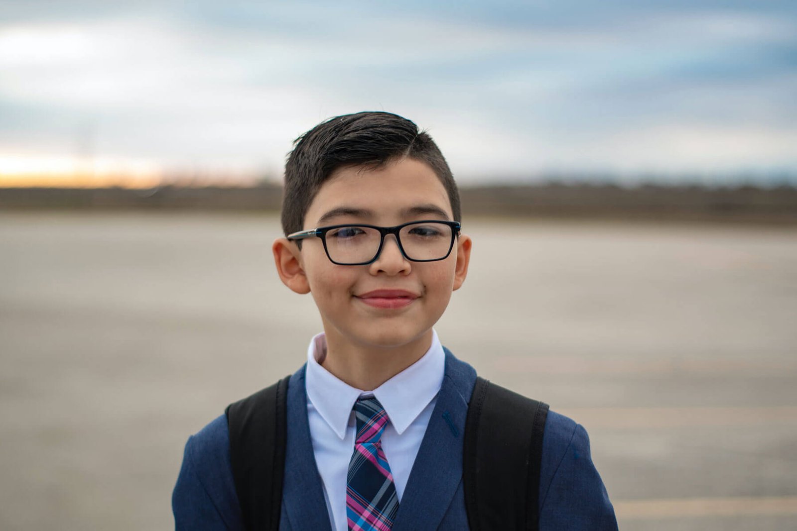CharterSchoolFAQ young boy in uniform smiling at the camera